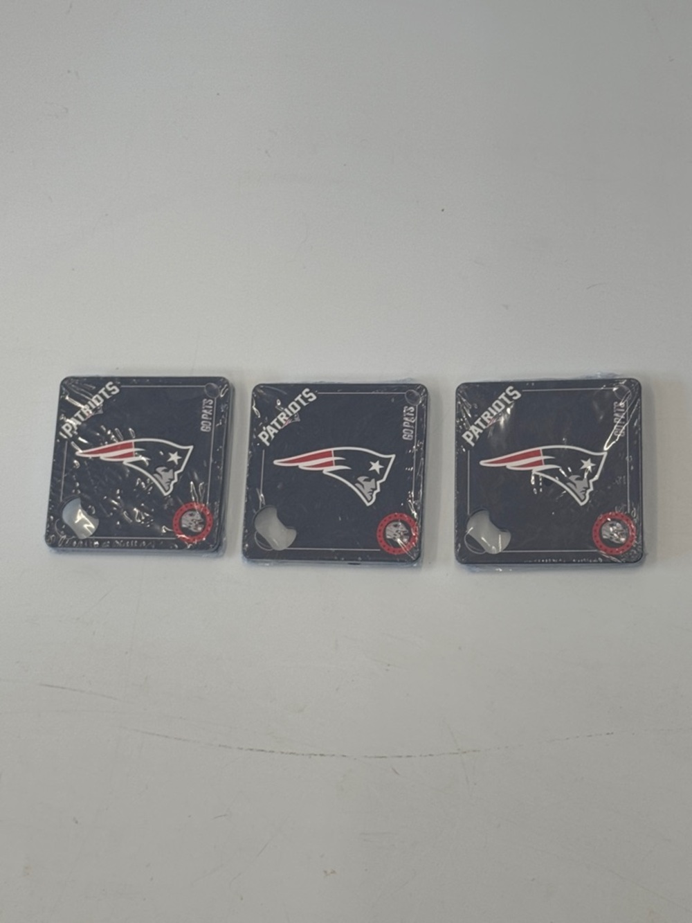 Set of 12 Metal “Patriots” Coasters with bottle opener.